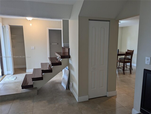 corridor with light tile patterned floors