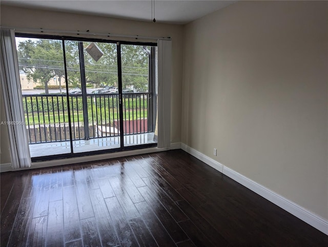 unfurnished room featuring a wealth of natural light and dark hardwood / wood-style floors