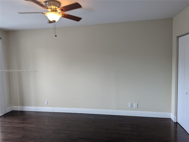 empty room featuring dark hardwood / wood-style flooring and ceiling fan