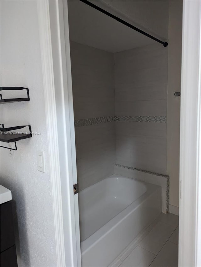 bathroom with tile patterned floors, tiled shower / bath combo, and vanity