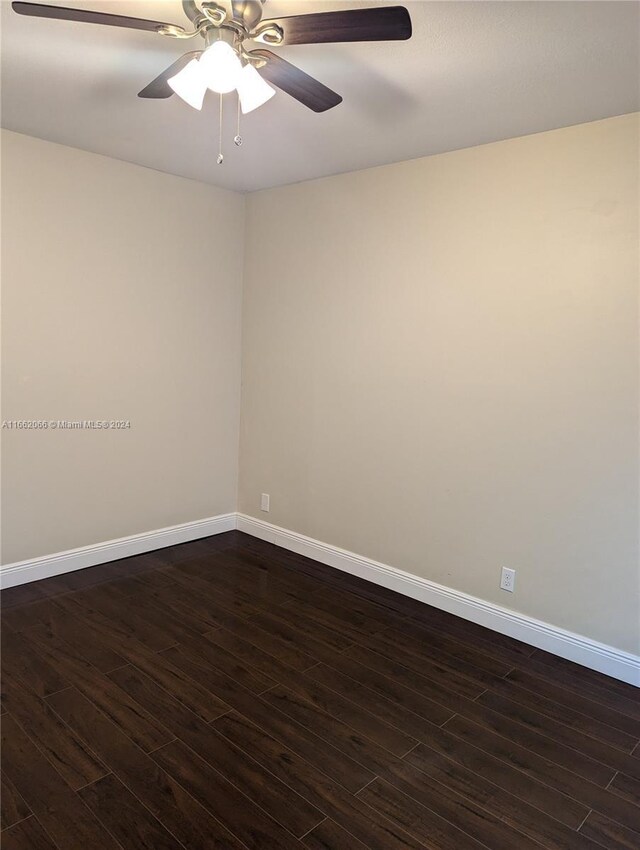 unfurnished room featuring ceiling fan and dark wood-type flooring