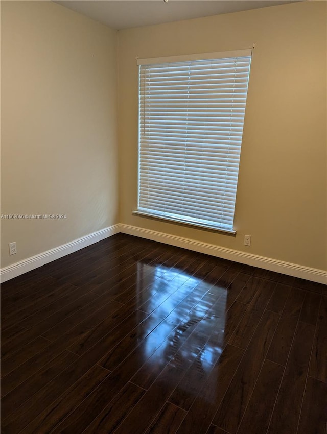 spare room featuring dark hardwood / wood-style floors