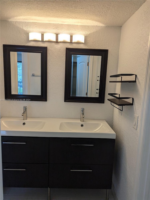 bathroom featuring a textured ceiling and vanity