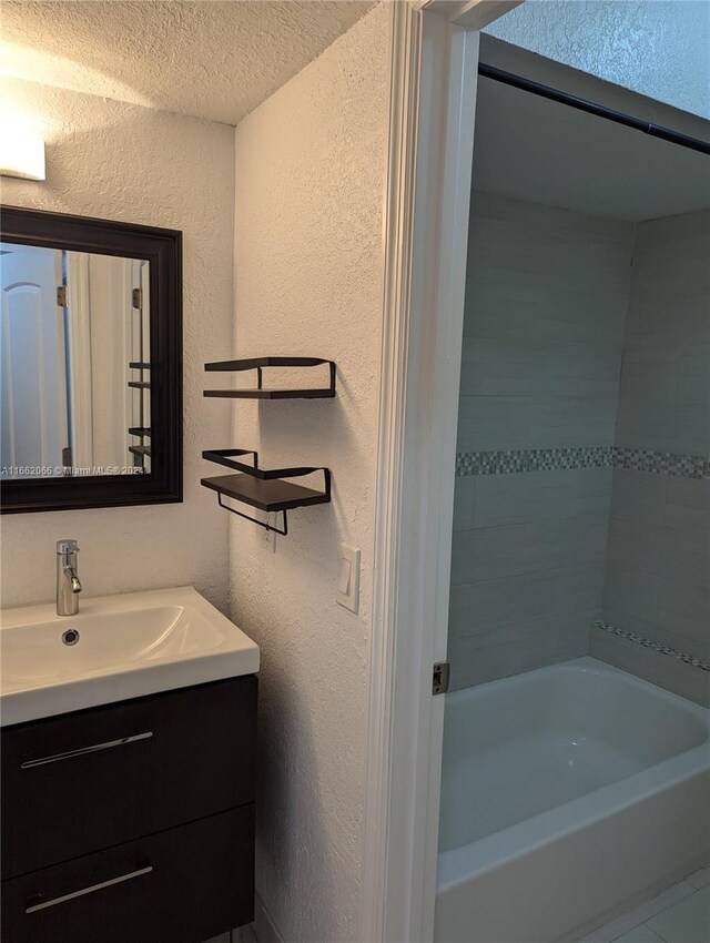 bathroom featuring a textured ceiling and vanity