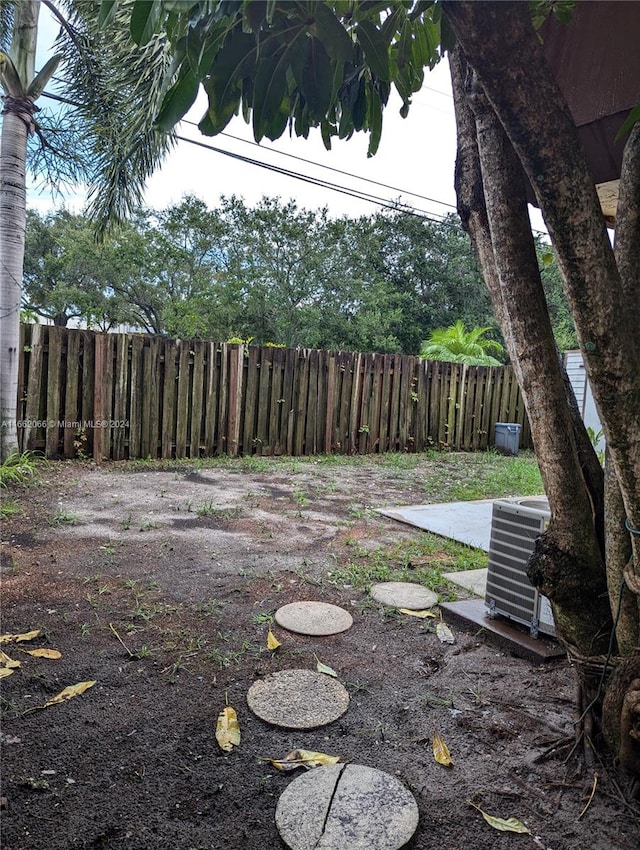 view of yard featuring central air condition unit