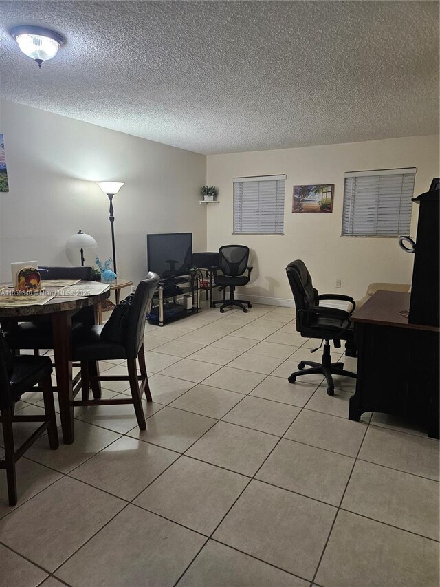 office with light tile patterned floors and a textured ceiling