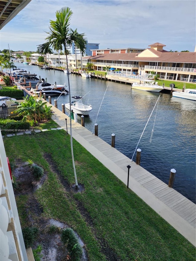 dock area featuring a water view and a yard