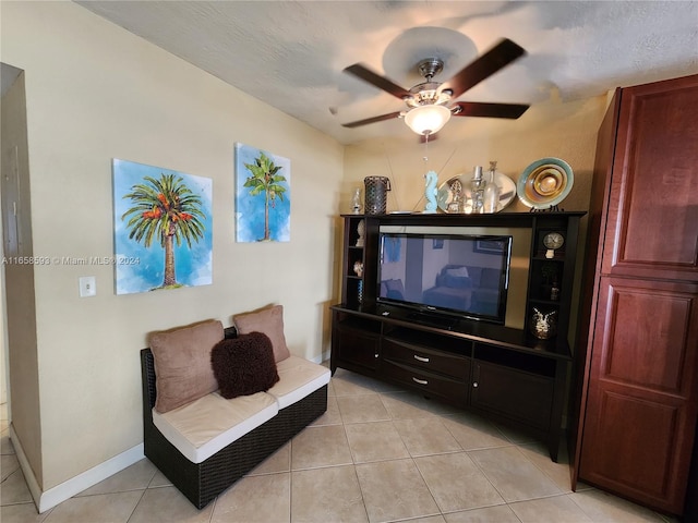 tiled living room featuring ceiling fan and a textured ceiling