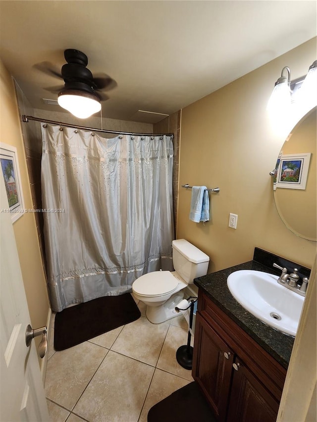 bathroom featuring vanity, tile patterned flooring, a shower with shower curtain, ceiling fan, and toilet