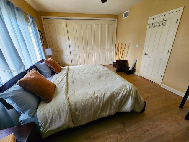 bedroom with hardwood / wood-style flooring and a closet