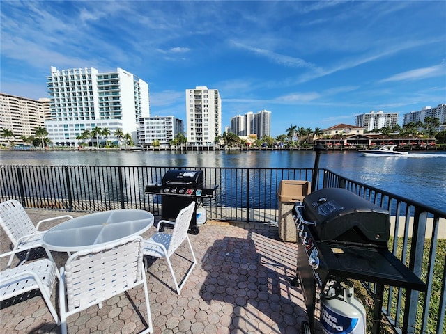 view of patio featuring area for grilling and a water view