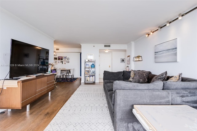 living room with hardwood / wood-style flooring and ornamental molding