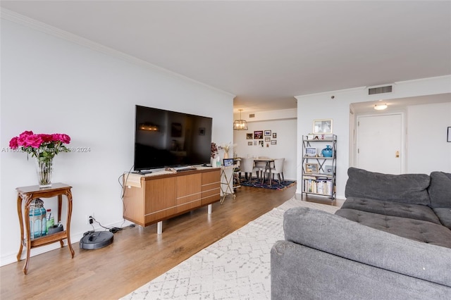 living room featuring ornamental molding and hardwood / wood-style flooring