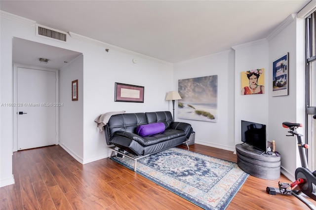 living room with ornamental molding and dark hardwood / wood-style floors