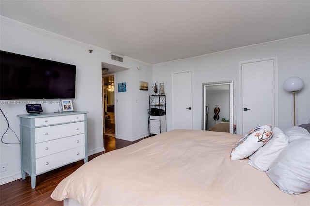 bedroom featuring ornamental molding and dark hardwood / wood-style flooring