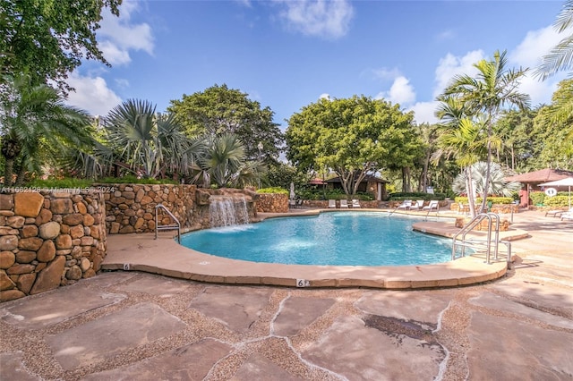 view of pool with pool water feature and a patio area