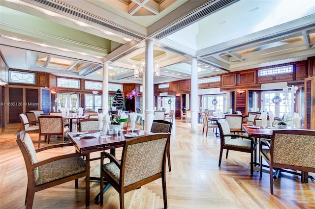 dining area with a chandelier, beamed ceiling, decorative columns, coffered ceiling, and light parquet floors