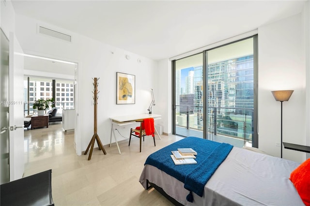 bedroom with access to outside and expansive windows