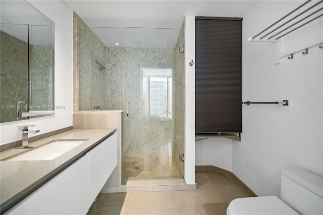 bathroom featuring vanity, tile patterned floors, a shower with shower door, and toilet