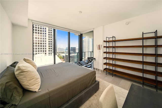 bedroom featuring light carpet and floor to ceiling windows