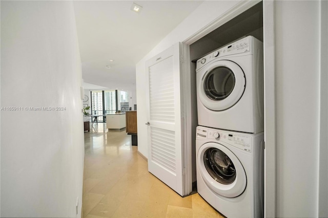 laundry area featuring stacked washer / drying machine