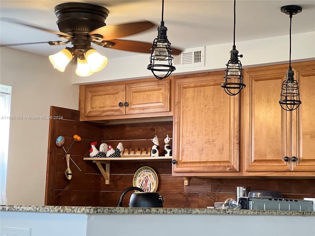 room details featuring hanging light fixtures, stone countertops, ceiling fan, and tasteful backsplash