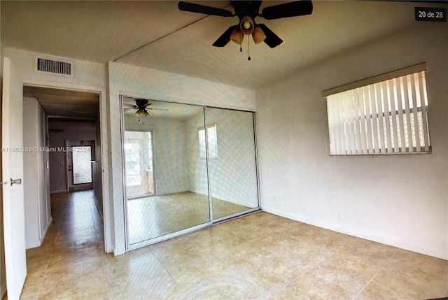 unfurnished bedroom with a closet and ceiling fan