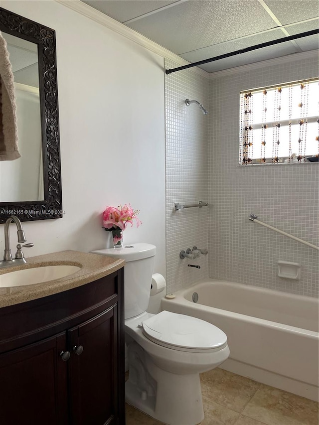 full bathroom with toilet, tiled shower / bath, vanity, ornamental molding, and tile patterned flooring