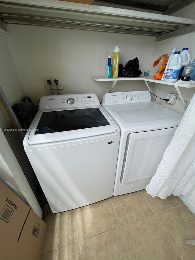 washroom featuring light tile patterned floors and separate washer and dryer