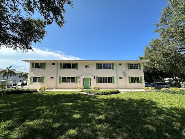 rear view of property with a yard