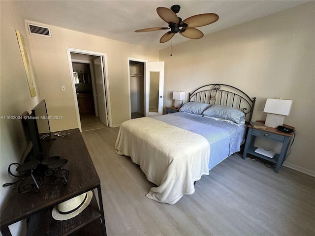 bedroom featuring a closet, light wood-type flooring, and ceiling fan