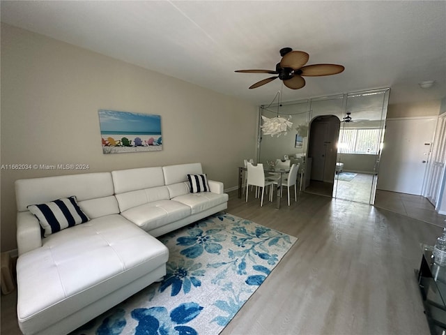 living room featuring hardwood / wood-style floors and ceiling fan