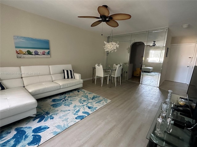 living room with ceiling fan and hardwood / wood-style flooring