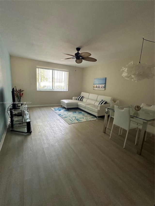 unfurnished living room featuring hardwood / wood-style floors and ceiling fan