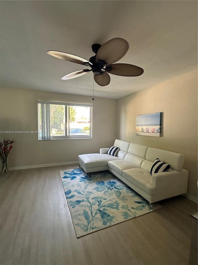 living room featuring ceiling fan and hardwood / wood-style flooring