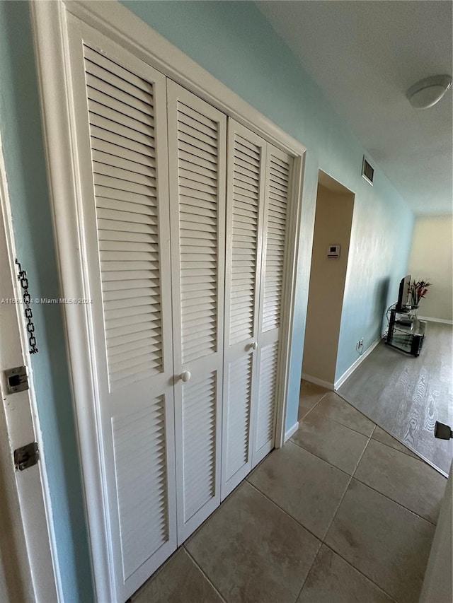 hallway featuring tile patterned flooring