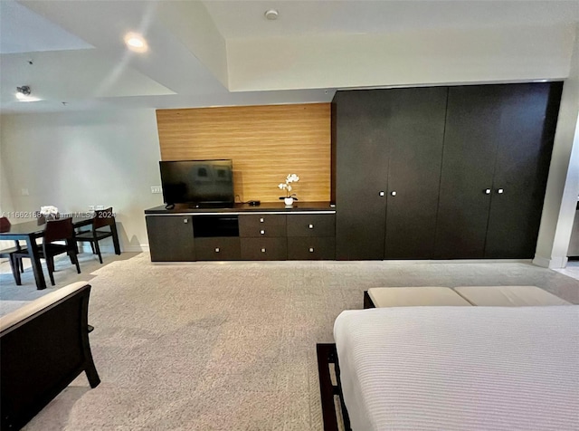 carpeted living room with wooden walls