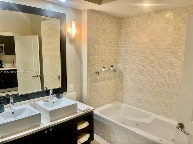 bathroom featuring vanity and tiled bath