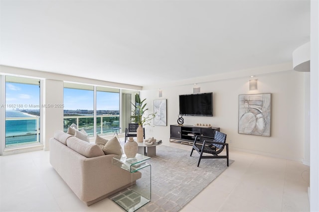 living room featuring a wall of windows, light tile patterned flooring, and a water view