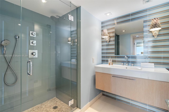 bathroom featuring walk in shower, tile patterned floors, vanity, and backsplash