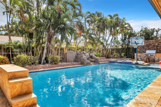 view of swimming pool with pool water feature