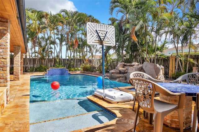 view of pool with pool water feature and an outdoor bar