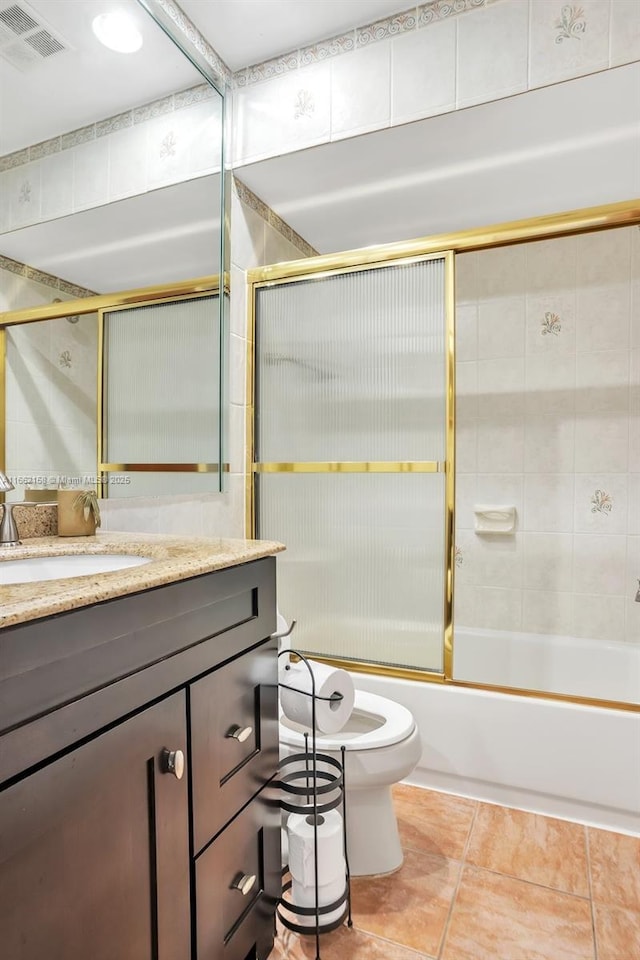 full bathroom featuring tile patterned flooring, vanity, toilet, and enclosed tub / shower combo