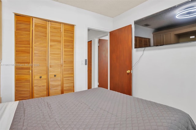 unfurnished bedroom featuring a closet and a textured ceiling