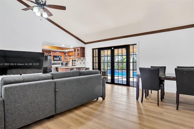 living room with ceiling fan, french doors, high vaulted ceiling, and light hardwood / wood-style floors