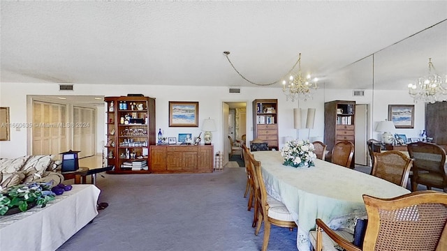 carpeted dining room with a notable chandelier and a textured ceiling