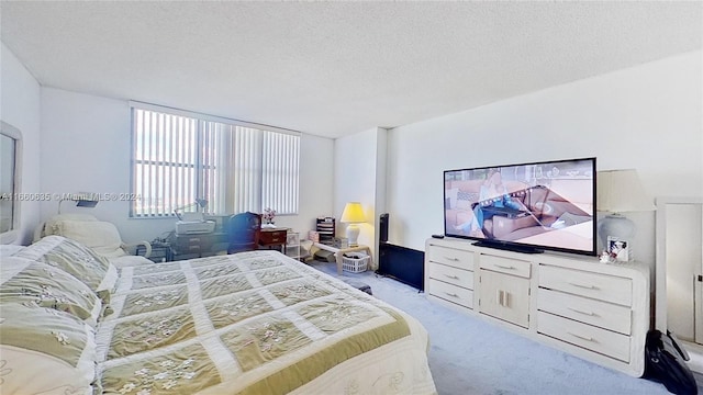 bedroom with light carpet and a textured ceiling