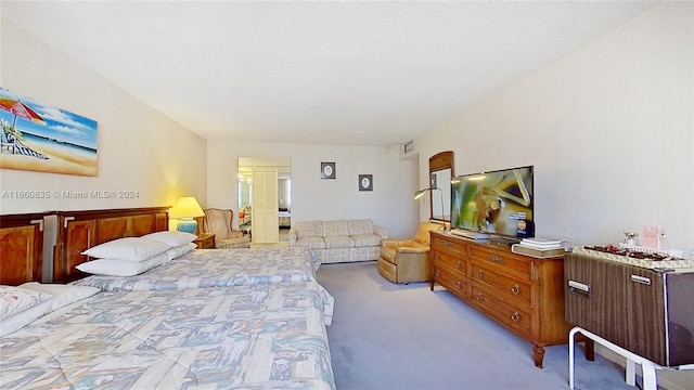 bedroom featuring light colored carpet