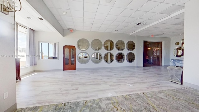 interior space with a paneled ceiling