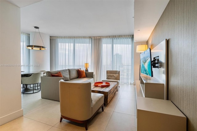 living area with a wealth of natural light, light tile patterned floors, and wallpapered walls